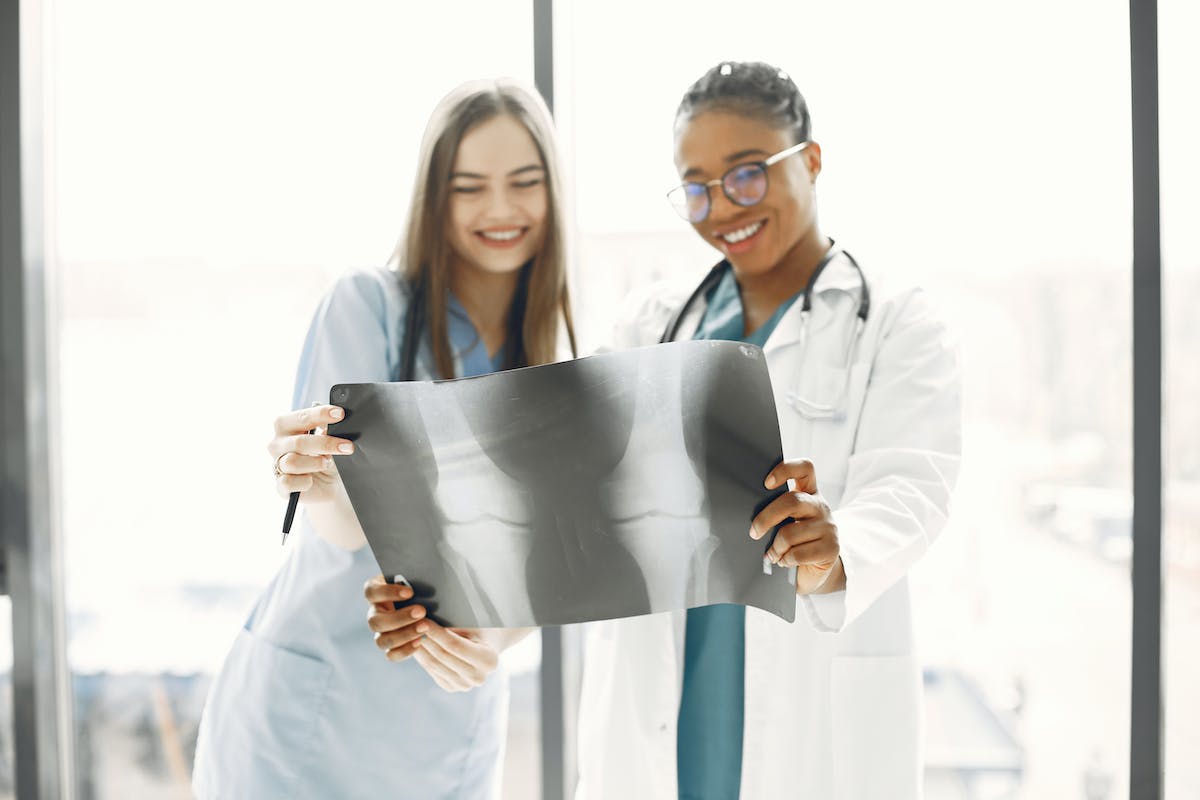 Doctor and Nurse Looking at an X-ray Picture and Smiling