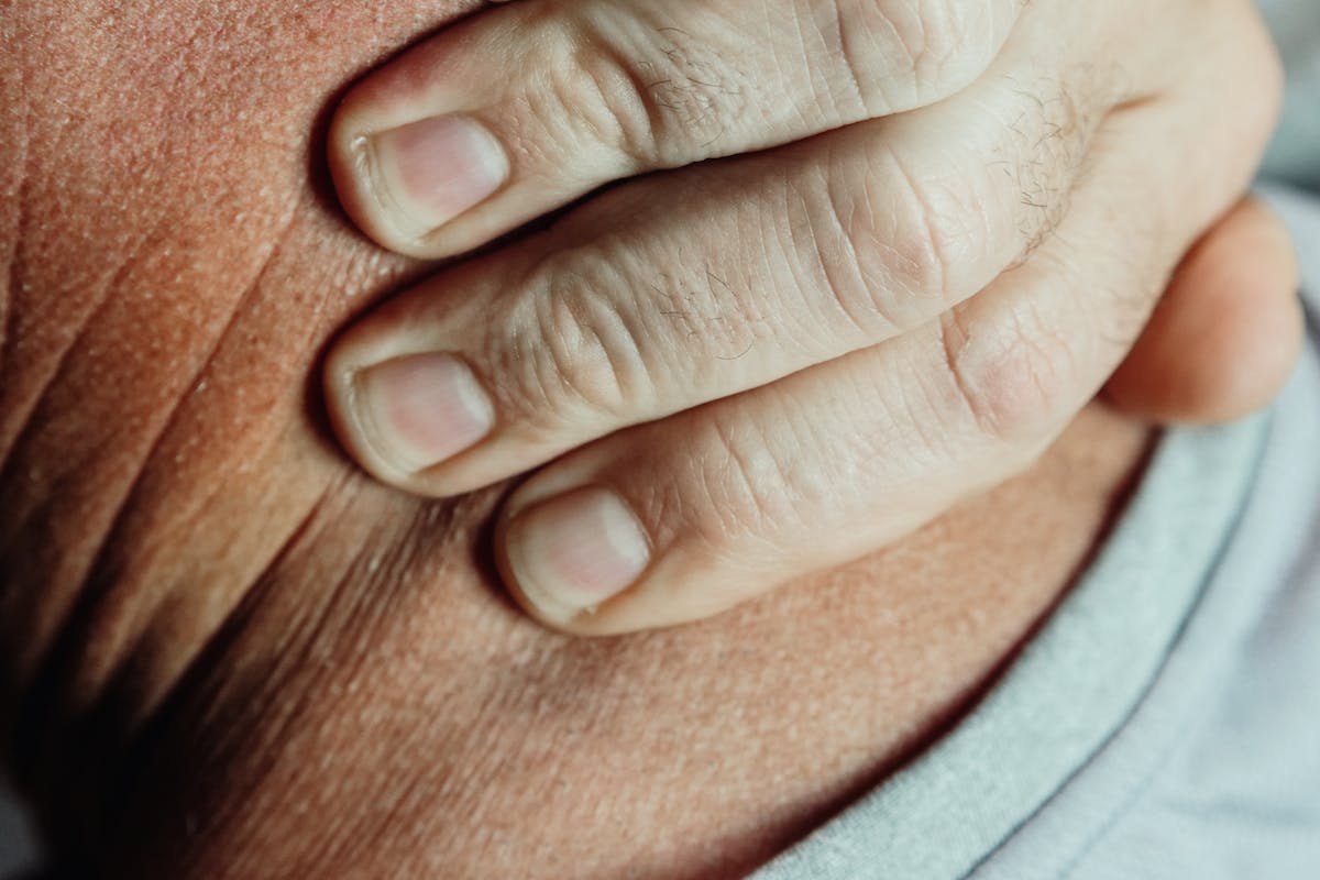 Close-Up Photo of a Person Having a Neck Pain