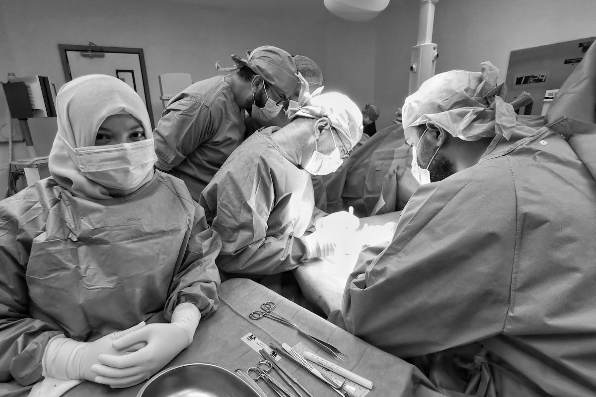 Person in Surgical Gown Looking at the Camera